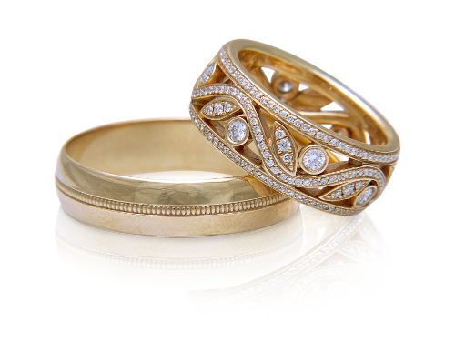 Two golden wedding rings on white background
