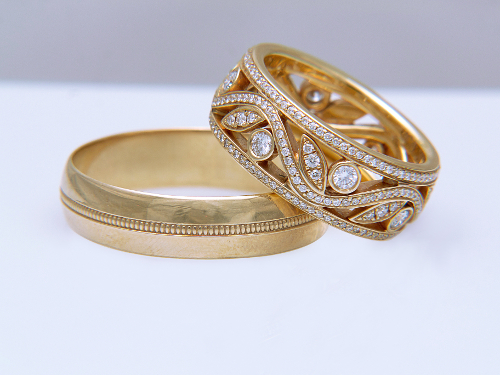 Two golden wedding rings on white background
